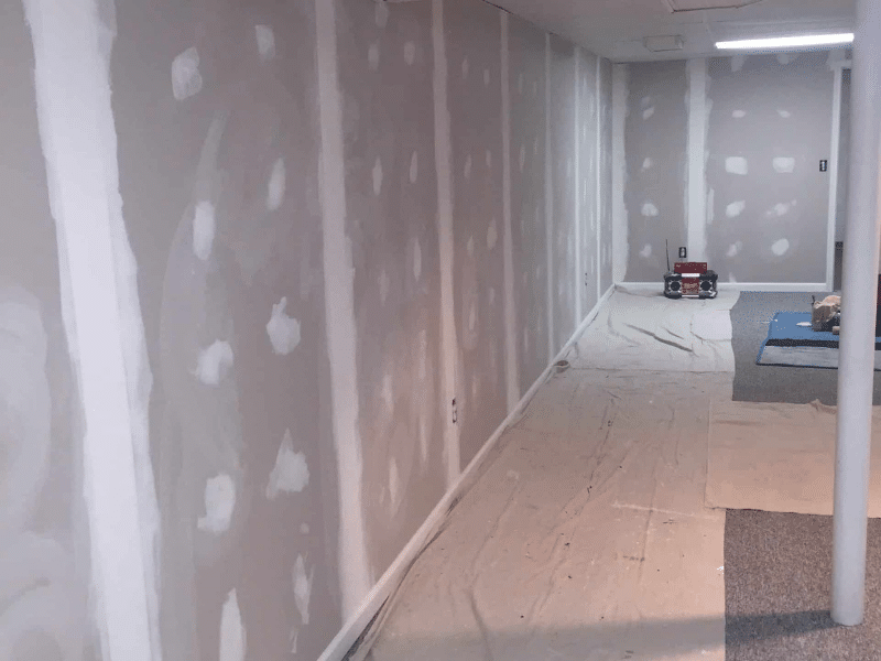 MR Paint technician assessing drywall damage in South Amboy home