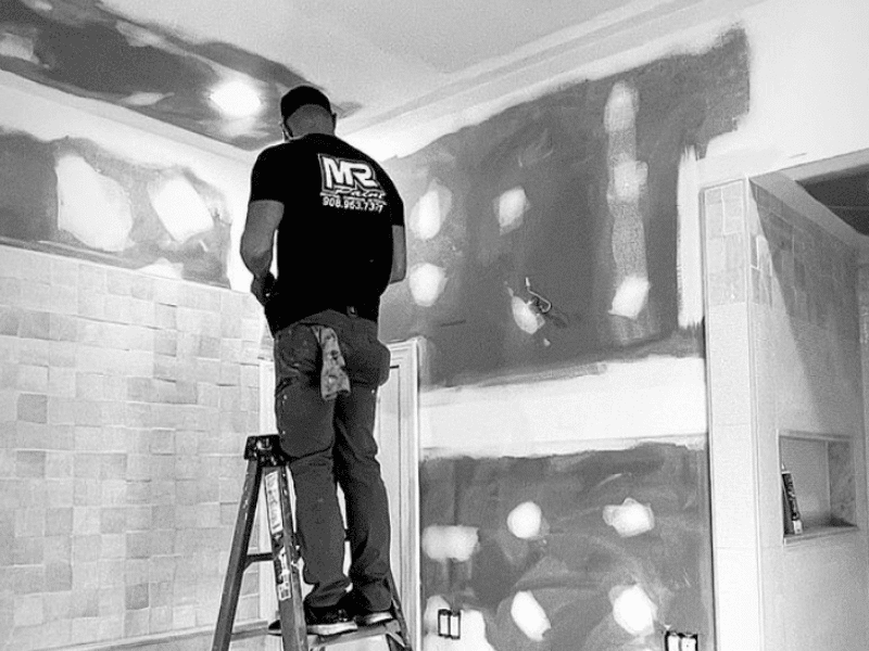 Close-up of drywall repair technique showing patching process