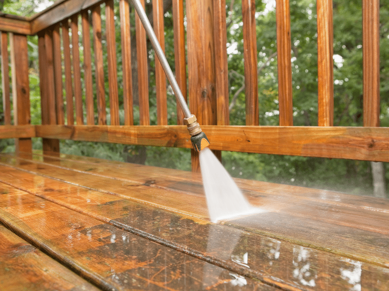 Wooden deck being powerwashed by MR Paint professional